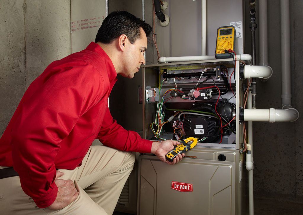 HVAC technician repairing an indoor furnace in Castle Rock
