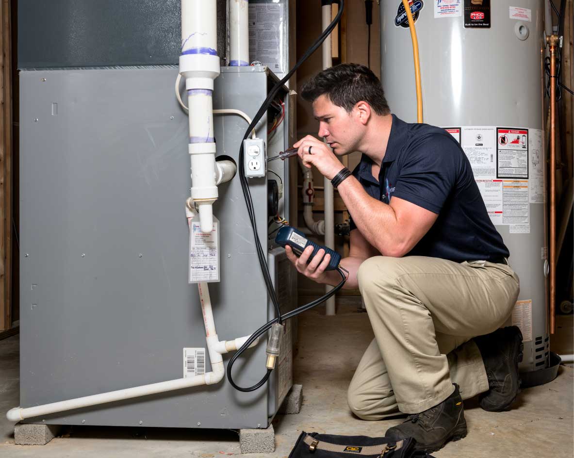 HVAC technician performing a furnace tune-up in Castle Rock