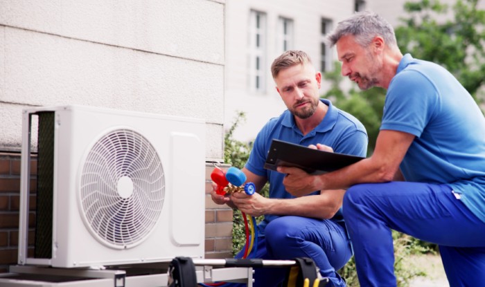 HVAC technicians installing an outdoor air conditioning unit in Castle Rock