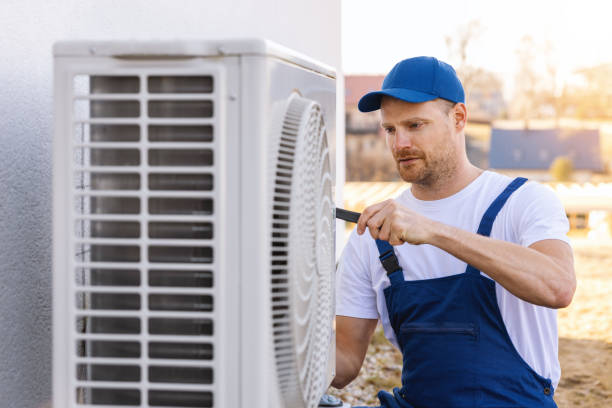HVAC technician servicing an outdoor air conditioning unit in Castle Rock