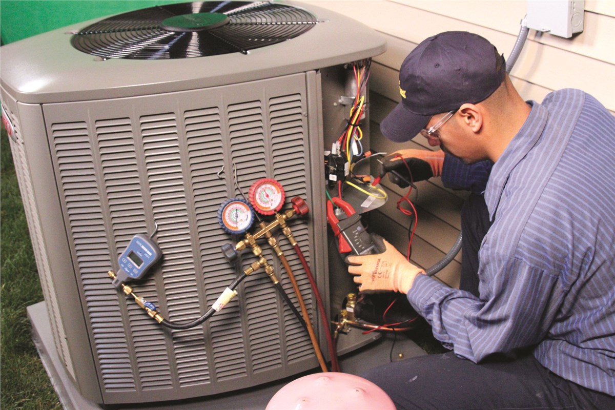 HVAC technician testing an outdoor air conditioning unit in Castle Rock